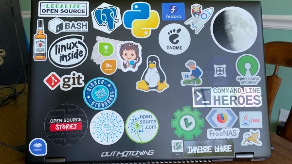 Alan Formy-Duval's laptop with various linux decals