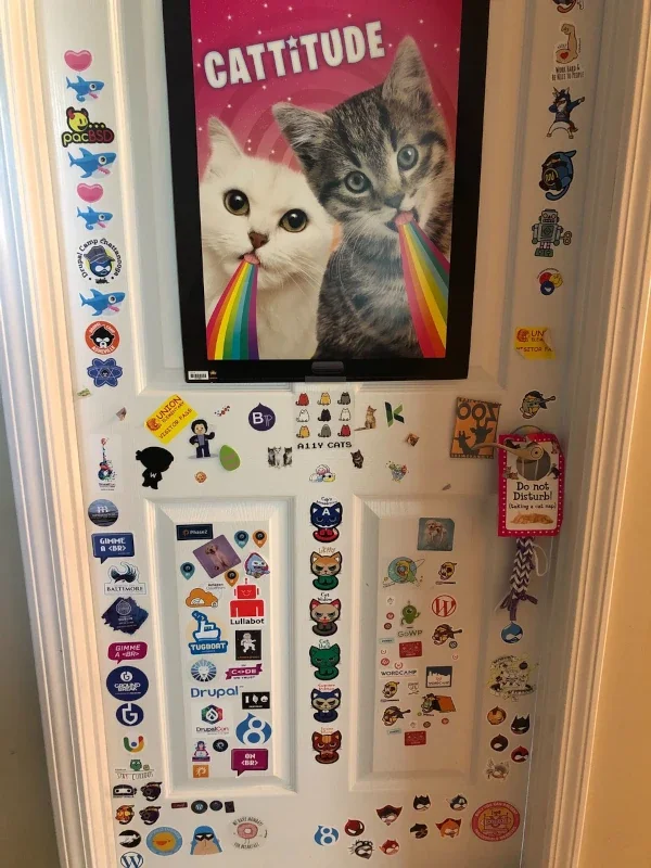 Cindy William's daughter's door covering tale to stern with decals from various WordPress and Drupal Camps