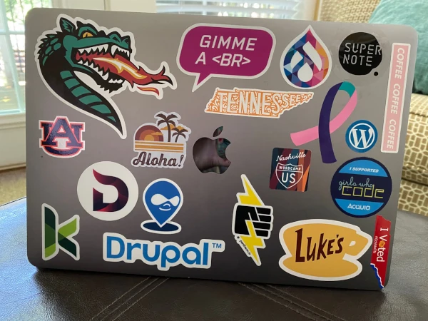 Cindy William's laptop with various decals including a Kanopi sticker and Glimore Girls decals