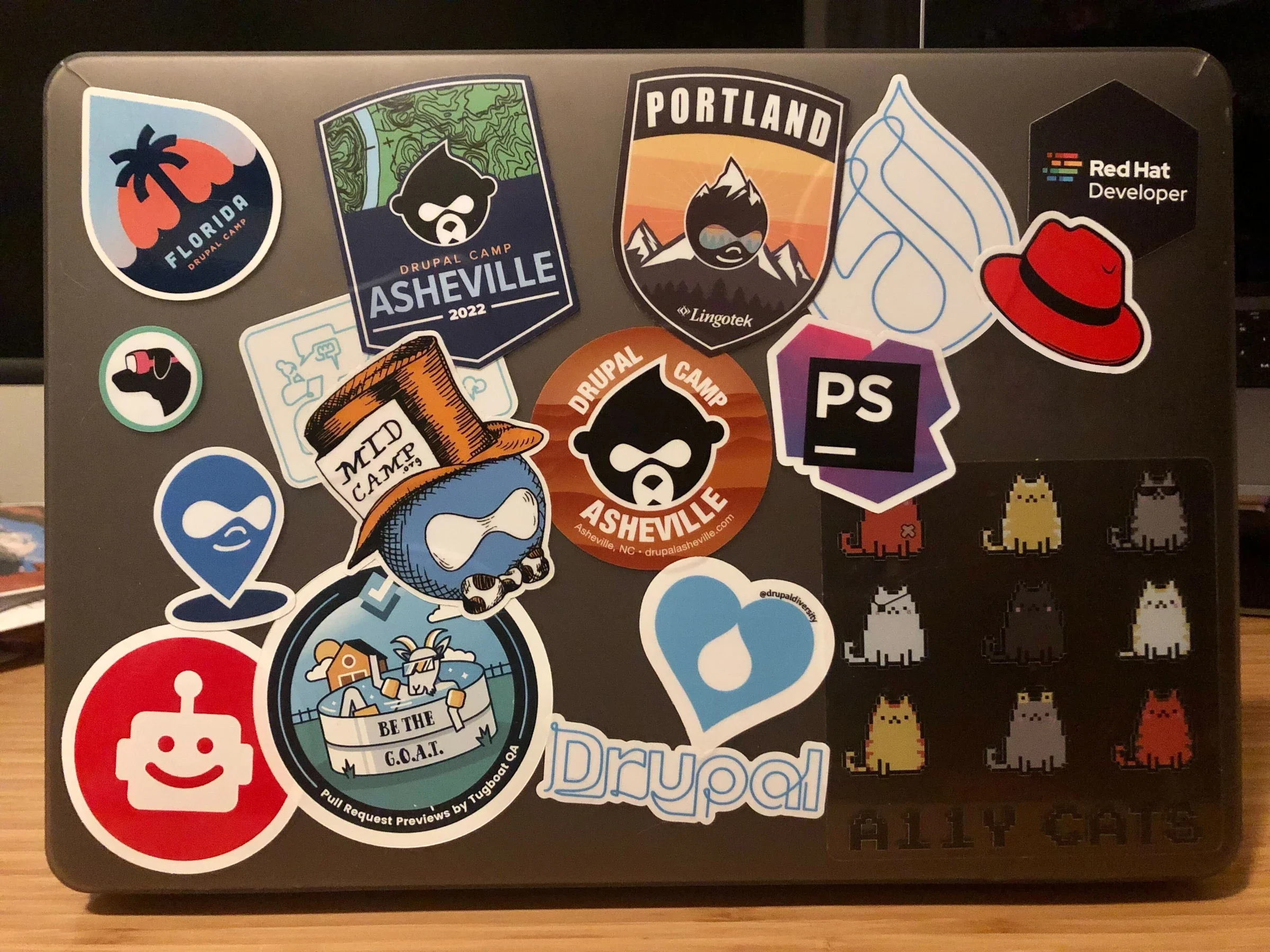 April's laptop features several Drupal stickers.