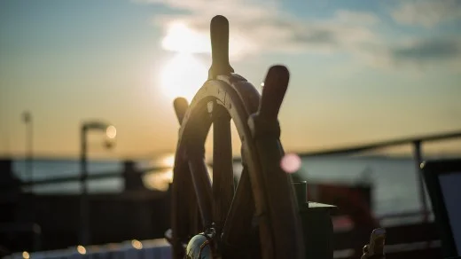 Boat helm at sunset for navigation