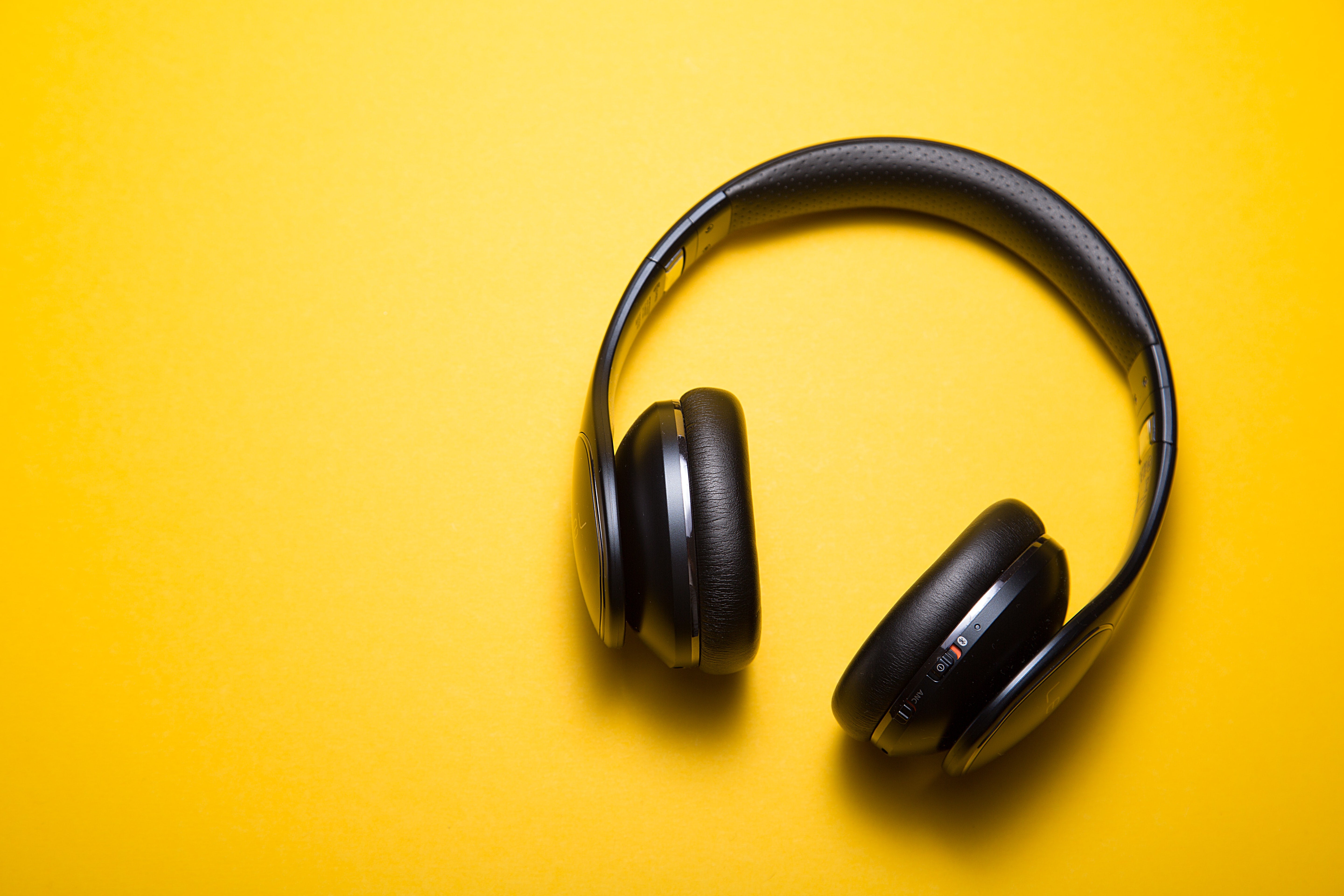 Headphones on a yellow backdrop