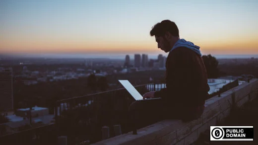 Guy on a laptop on a building