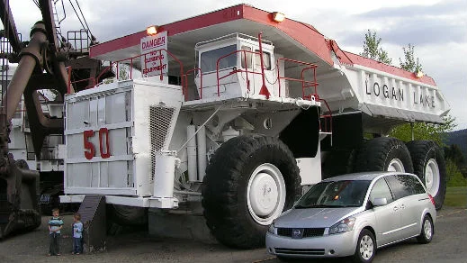 Dump truck with kids standing in the foreground