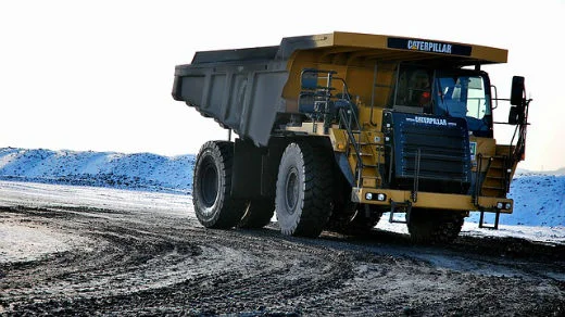 Dump truck rounding a turn in the road