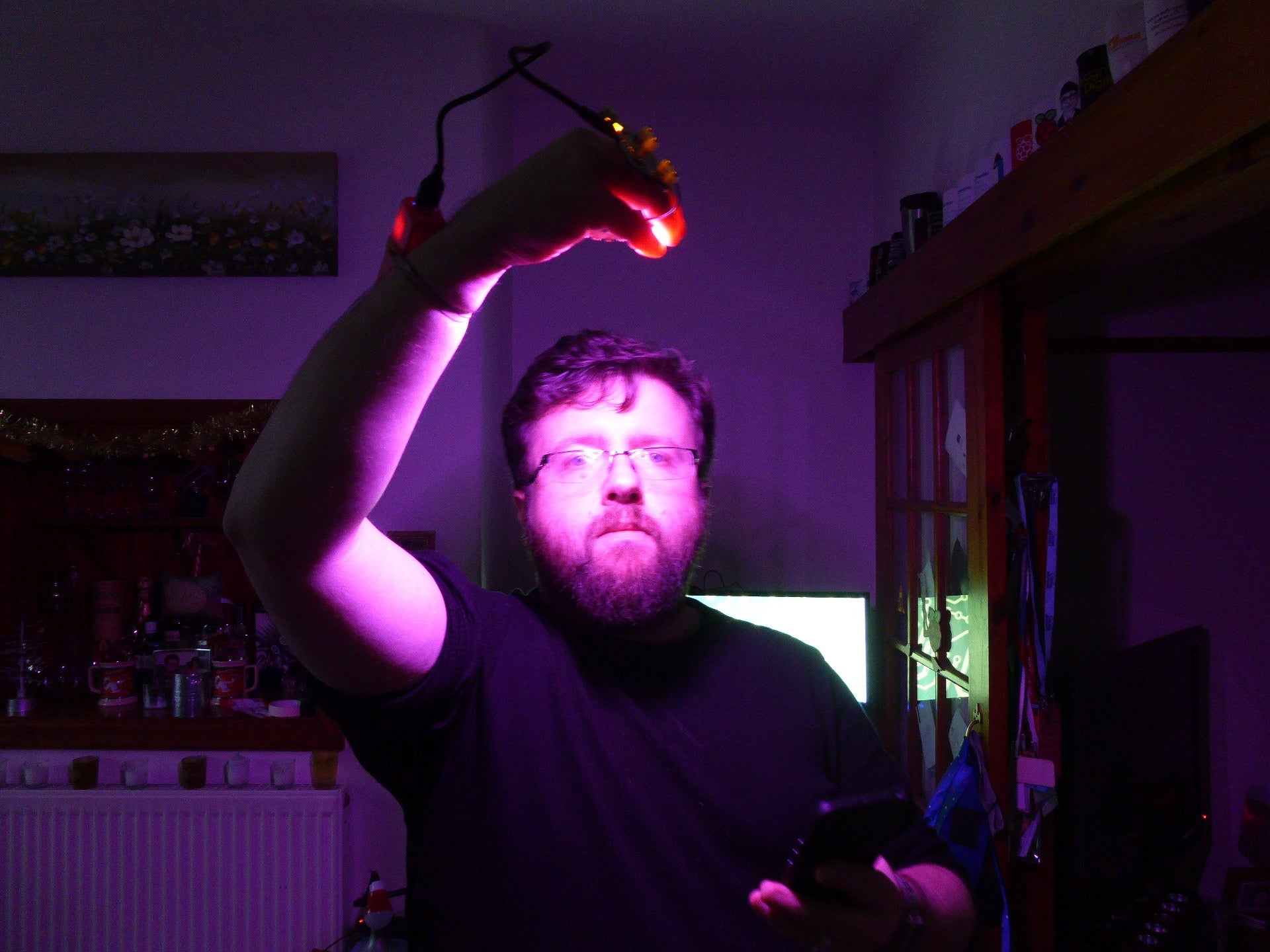 Les, holding a neopixel powered glove light to his face