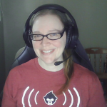 Woman with brown hair, glasses, and headset in a red t-shirt