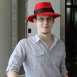 A man in a red hat signifying the Opensource company called Red Hat