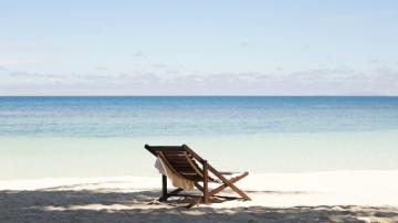 One chair on a sandy beach
