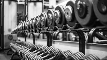 gray scale photo of dumbbell weights for strength training