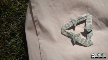 Dollar bills folded into arrows