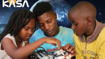 Youth working with a robot program