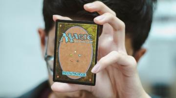 Holding a Magic the Gathering deckmaster card