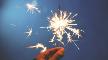 hand holding lit sparkler