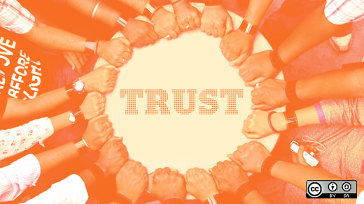 Hands together around the word trust