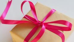 Package wrapped with brown paper and red bow