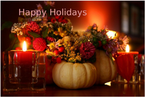 A candlelight centerpiece using pumpkin shells as flower holders for small red and yellow floral bouquets, with the words "Happy Holidays" at the top left of the image